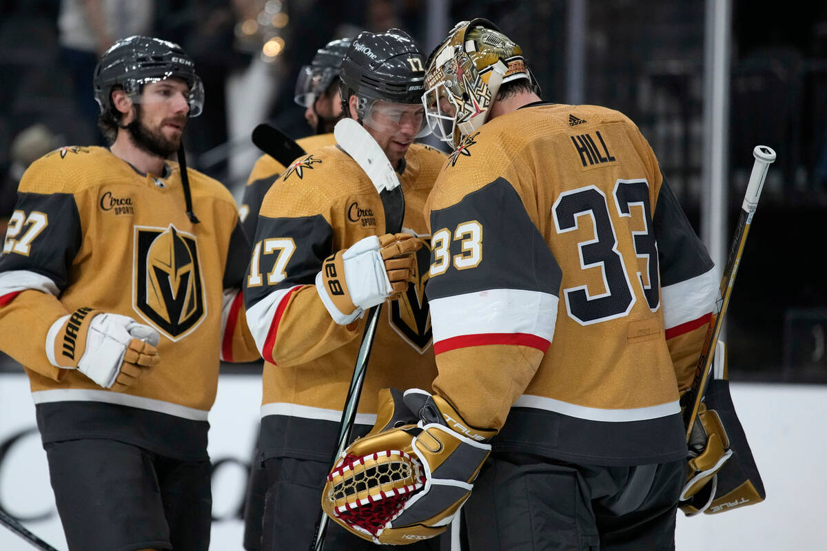 Vegas Golden Knights defenseman Ben Hutton (17) and goaltender Adin Hill (33) celebrate after d ...