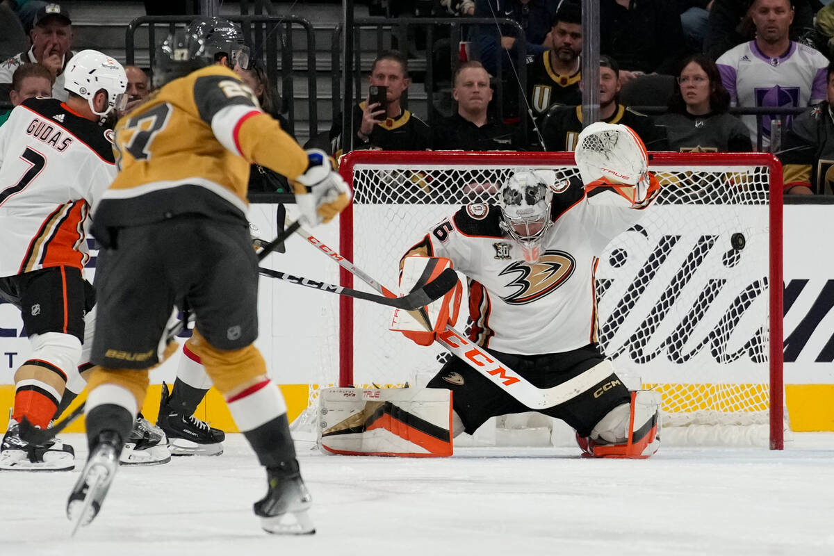 Vegas Golden Knights defenseman Shea Theodore, left, scores on Anaheim Ducks goaltender John Gi ...