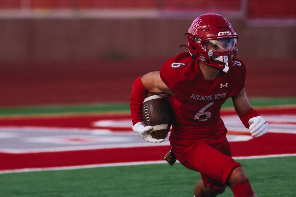 Arbor View wide receiver Jayden Williams runs the ball down the field during a game against Lib ...