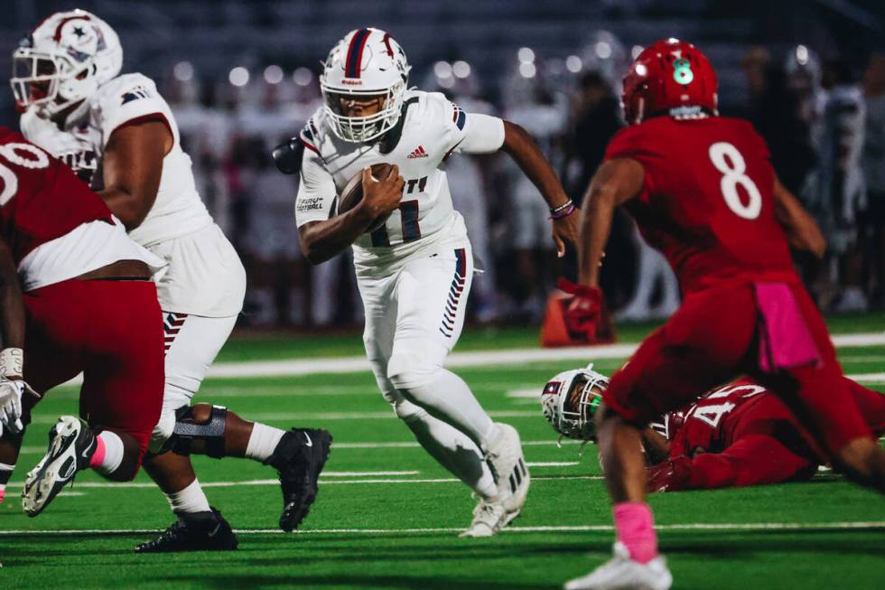 Liberty quarterback Tyrese Smith (11) runs the ball down the field during a game against Arbor ...