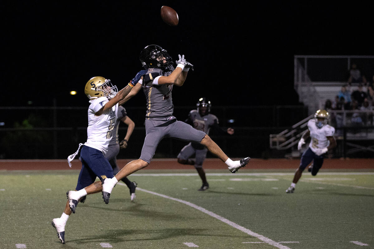 Faith Lutheran’s Brandon Soares (2) attempts to catch an interception on a pass intended ...