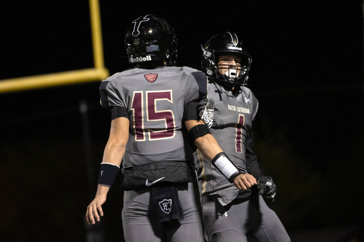 Faith Lutheran wide receiver Griffin Carty (1) celebrates his touchdown with quarterback Alex R ...
