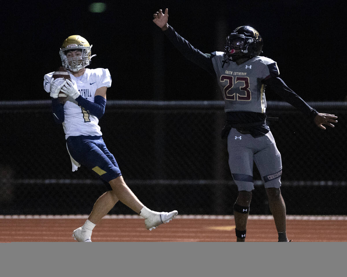 Foothill wide receiver Travis Kenzevich (1) catches a pass while Faith Lutheran running back Wa ...