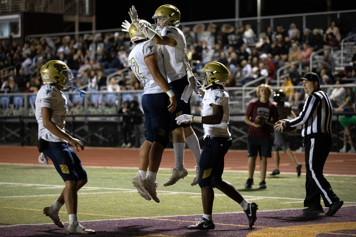 Foothill tight end Cade Nielson (12) and wide receiver Devon Wake (11) bump chests to celebrate ...