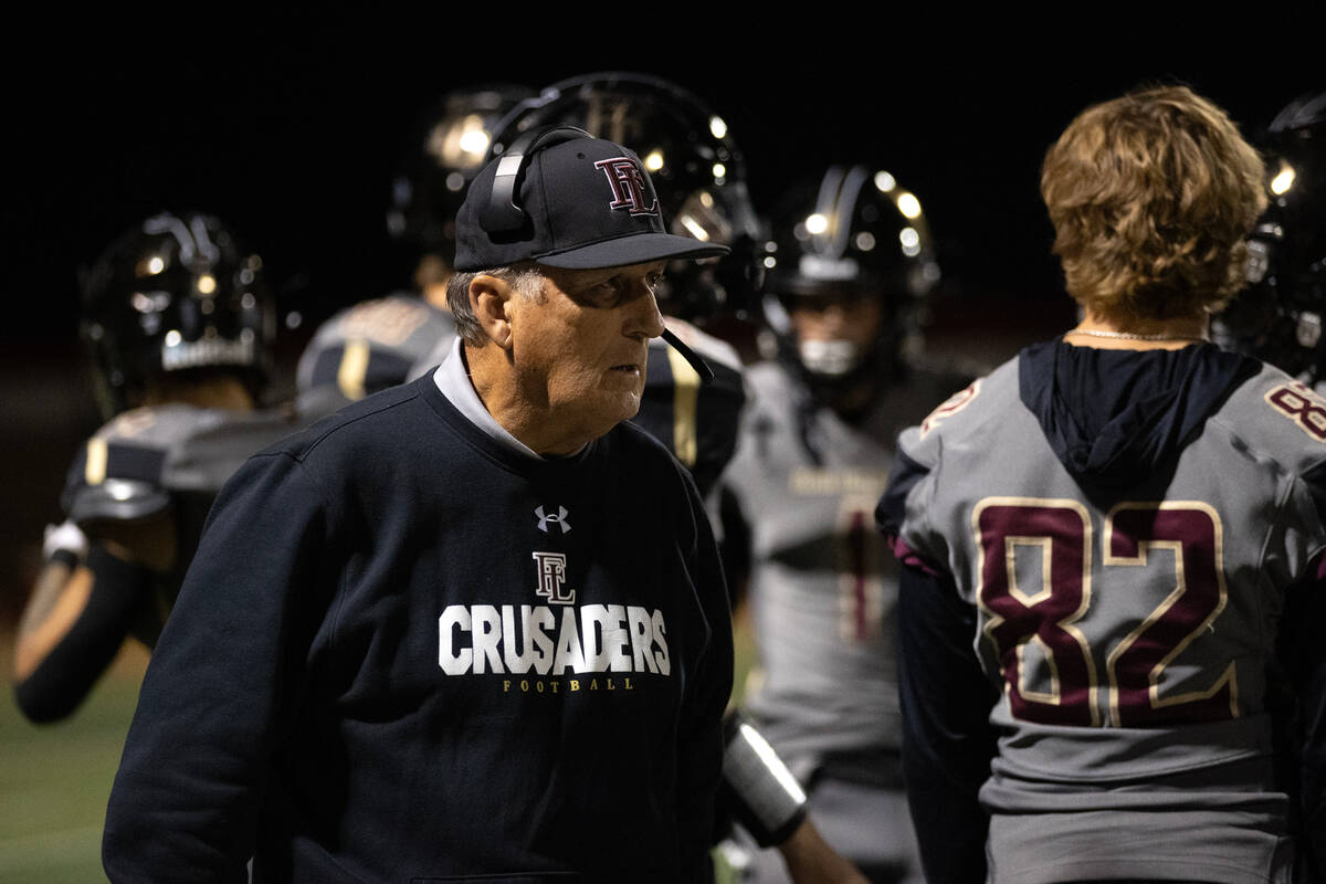 Faith Lutheran head coach Michael Sanford paces the sidelines during the first half of a high s ...