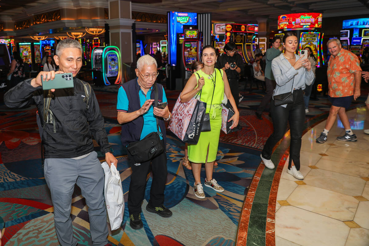 Bellagion guests watch as Cirque du Soleil performers walk in the “O” anniversary ...