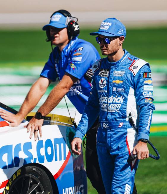 Kyle Larson walks out with his race car onto the track at the Las Vegas Motor Speedway on Satur ...