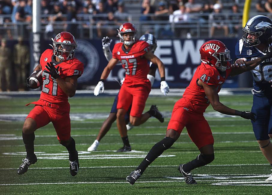 UNLV’s Jacob De Jesus looks to run while taking on Nevada at Mackay Stadium in Reno on Oct. 1 ...