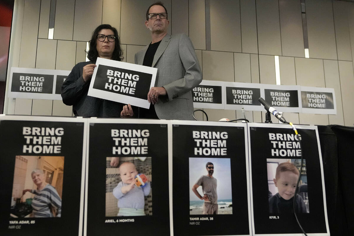 Sharon Lifschitz, left, and Noam Sagi pose for photographers after a press conference of Britis ...