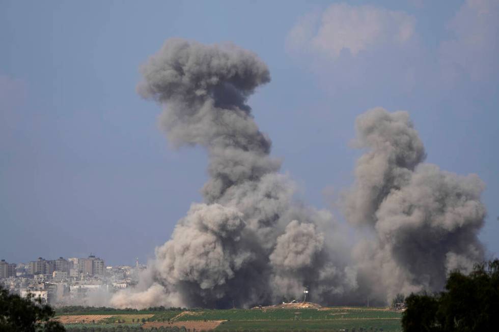 Smoke rises following an Israeli airstrike in the Gaza Strip, as seen from southern Israel, Fri ...