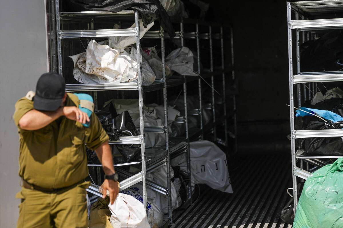 The bodies of Israelis killed in an unprecedented Hamas terrorist attack are gathered for ident ...