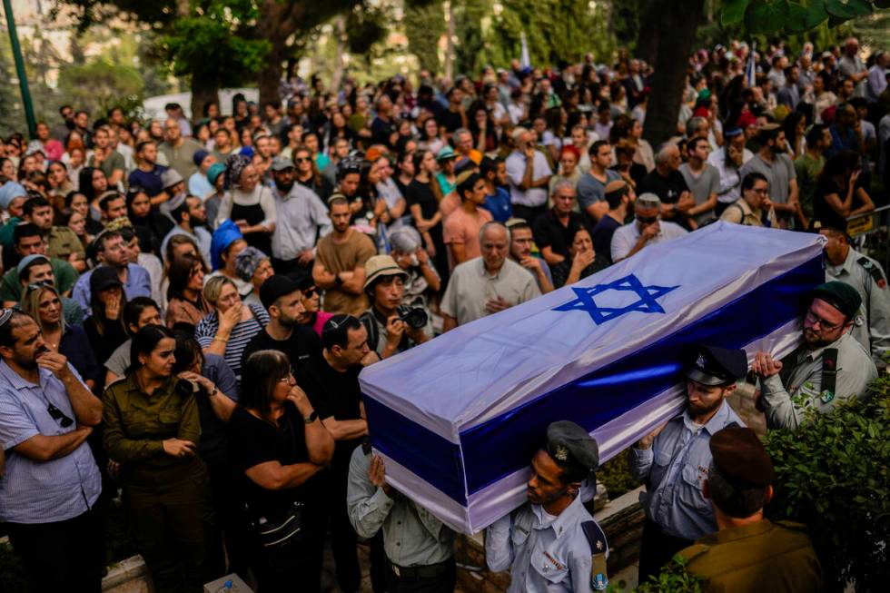 Israeli soldiers carry the flag-covered coffin of Shilo Rauchberger at the Mount Herzl cemetery ...