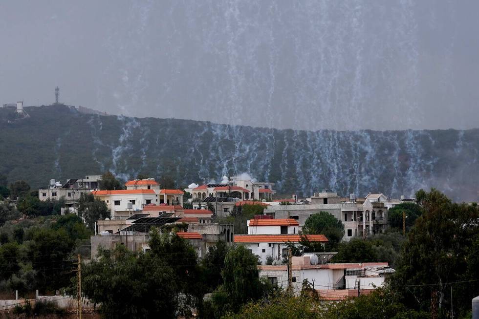 A shell from Israeli artillery explodes over Aita al-Shaab a Lebanese border village with Israe ...