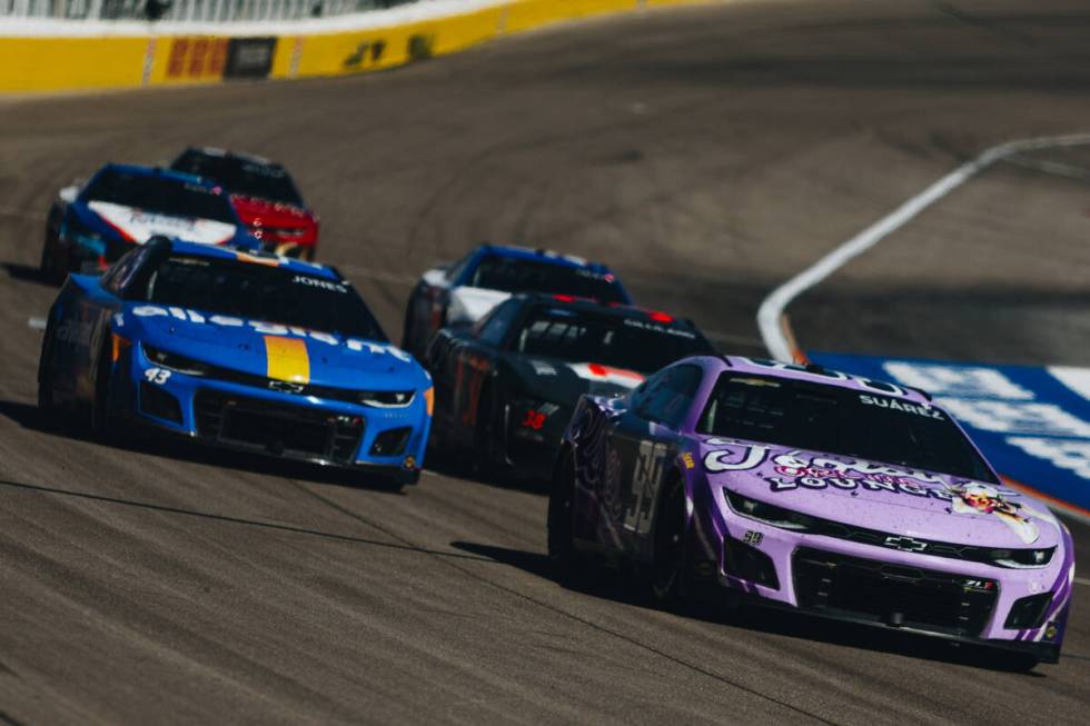 Race cars speed throughout the track during the South Point 400 at the Las Vegas Motor Speedway ...