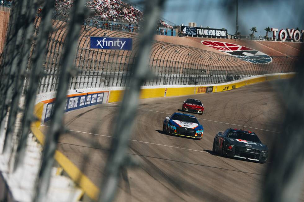 Race cars speed throughout the track during the South Point 400 at the Las Vegas Motor Speedway ...