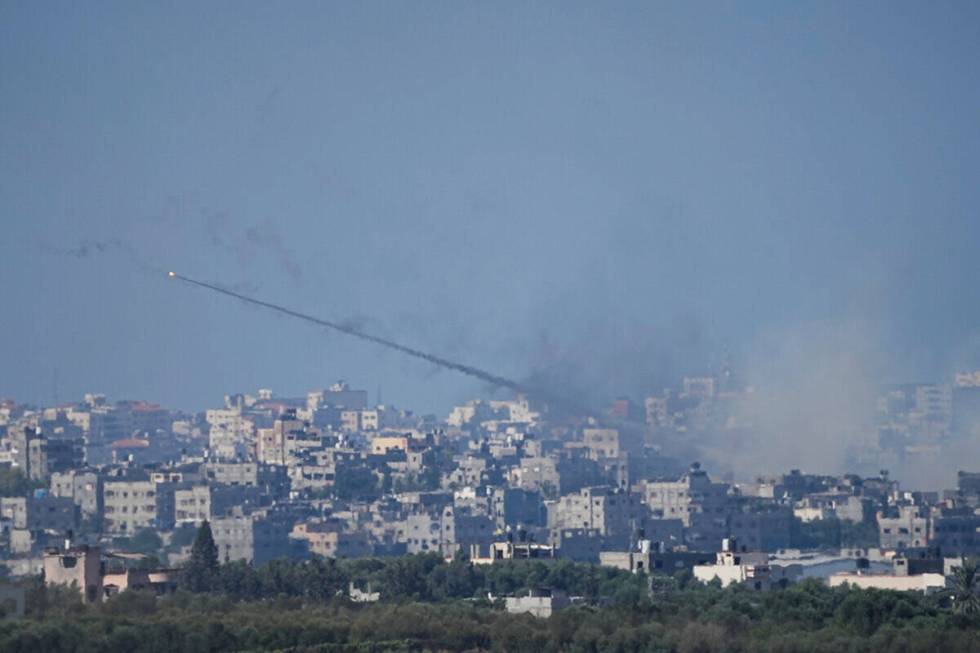 Rockets are fired toward Israel from the Gaza Strip, as seen from southern Israel, Sunday, Oct. ...