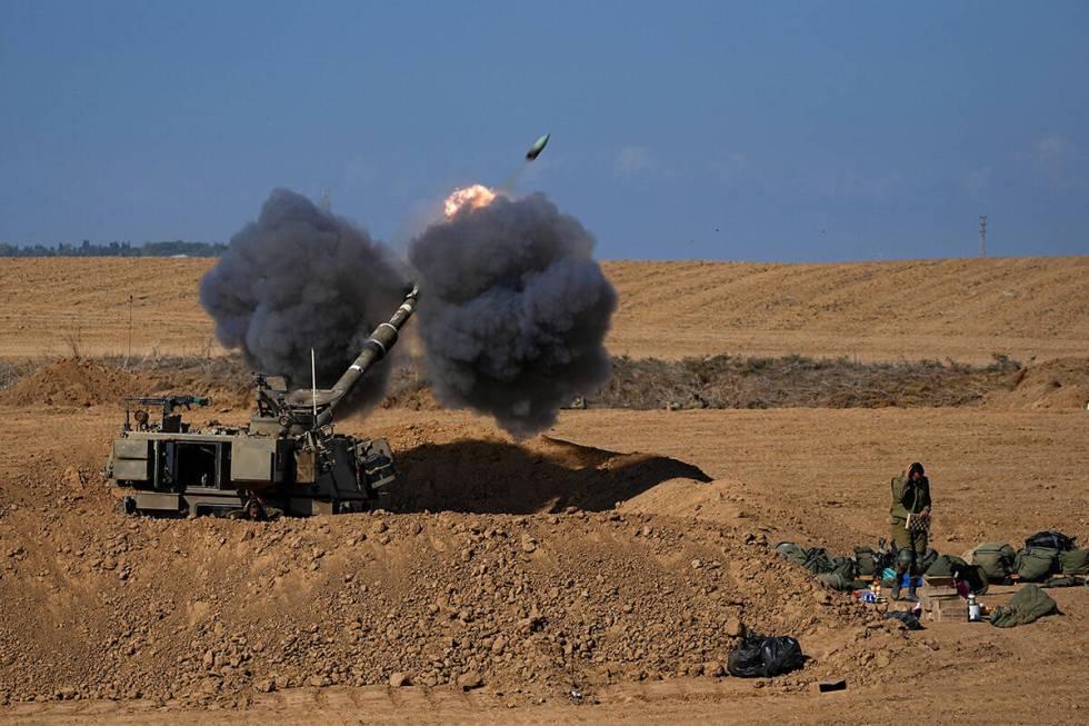 An Israeli mobile artillery unit fired a shell from southern Israel towards the Gaza Strip, in ...