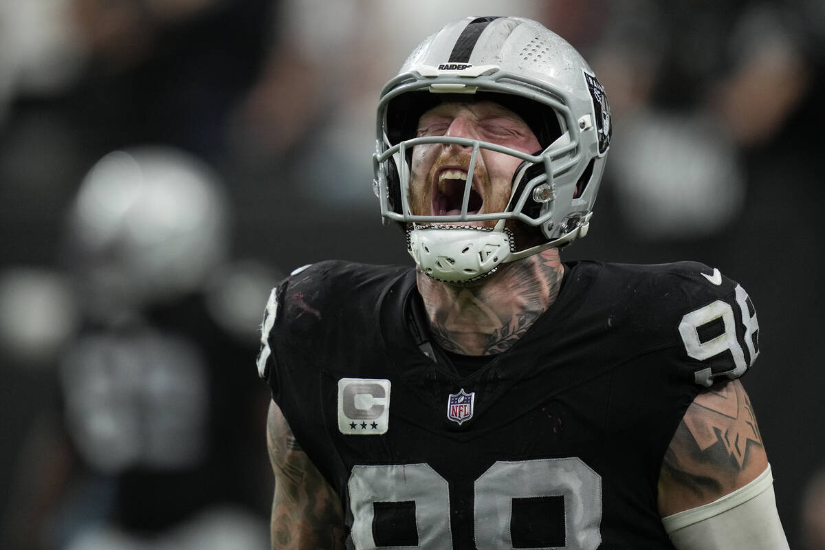 Las Vegas Raiders defensive end Maxx Crosby, right, celebrates his sack and safety during the s ...