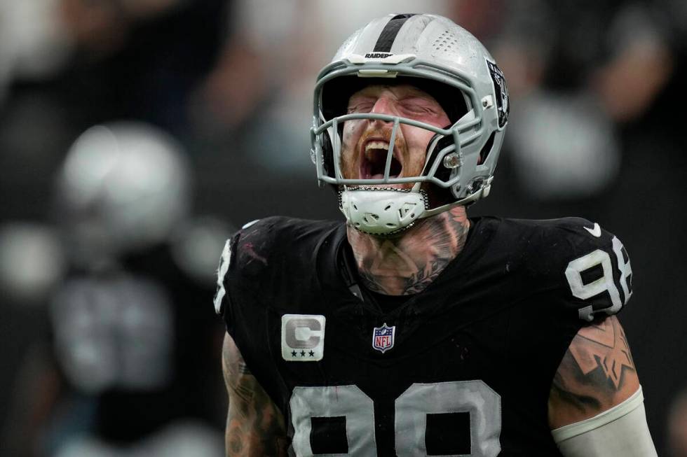 Las Vegas Raiders defensive end Maxx Crosby, right, celebrates his sack and safety during the s ...