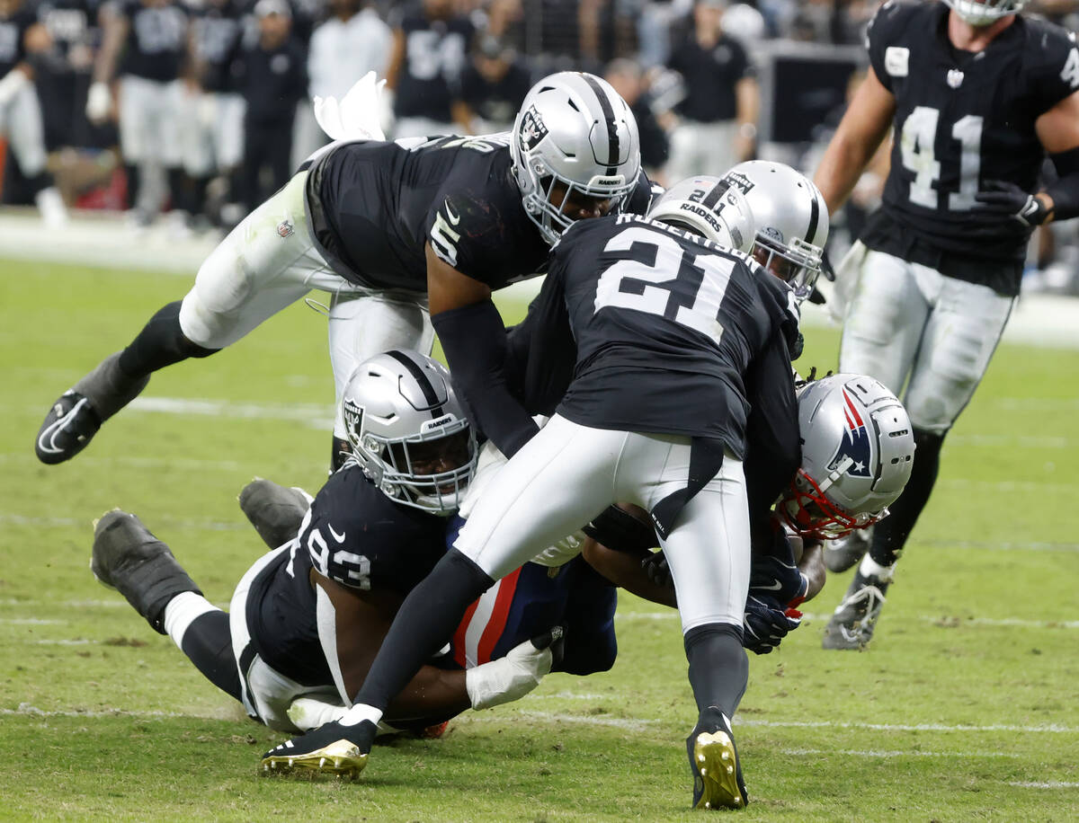 New England Patriots wide receiver Ty Montgomery II (14) tackled by Raiders linebacker Divine D ...