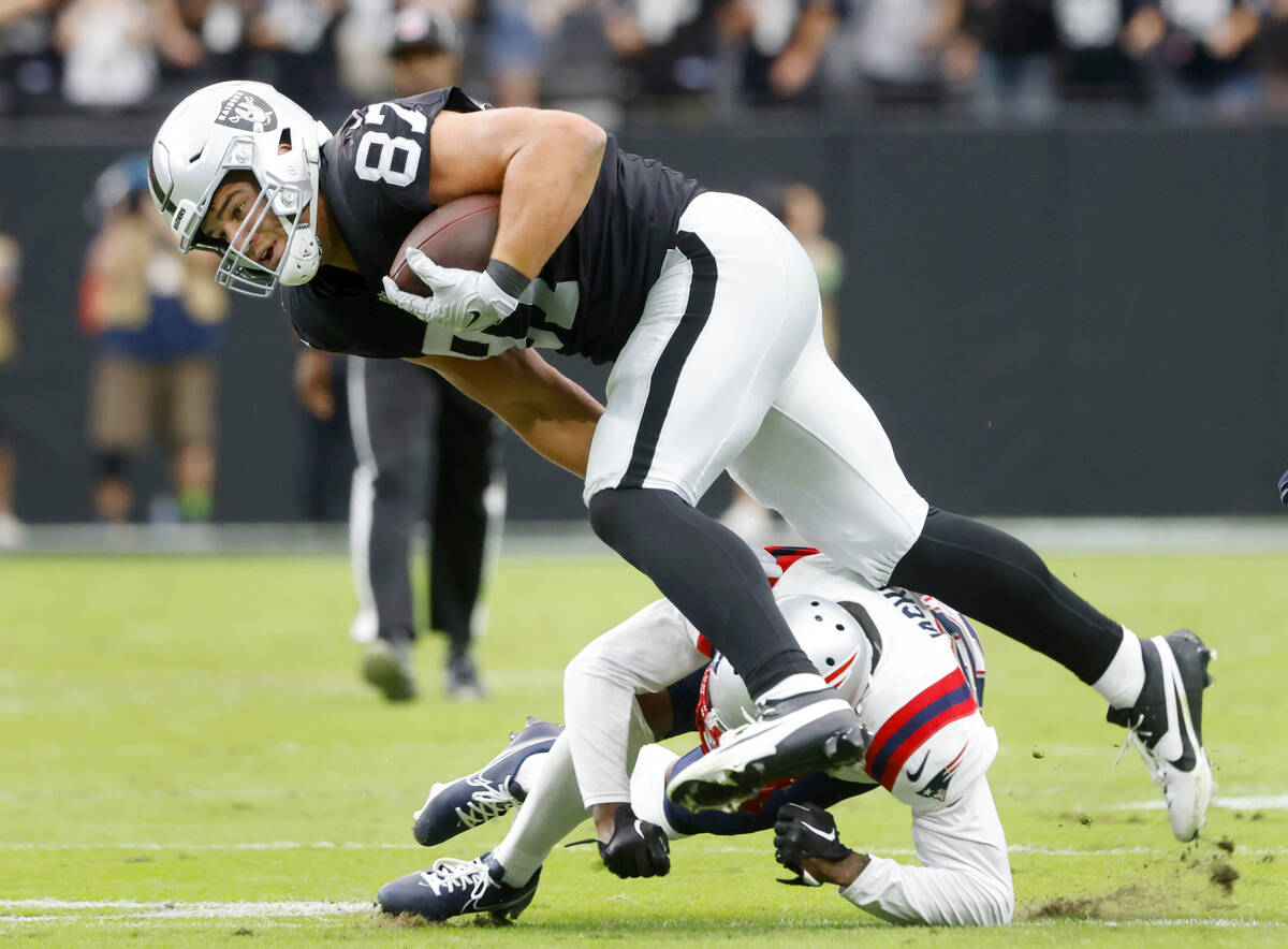 Raiders tight end Michael Mayer (87) avoids a tackle from New England Patriots cornerback Marcu ...