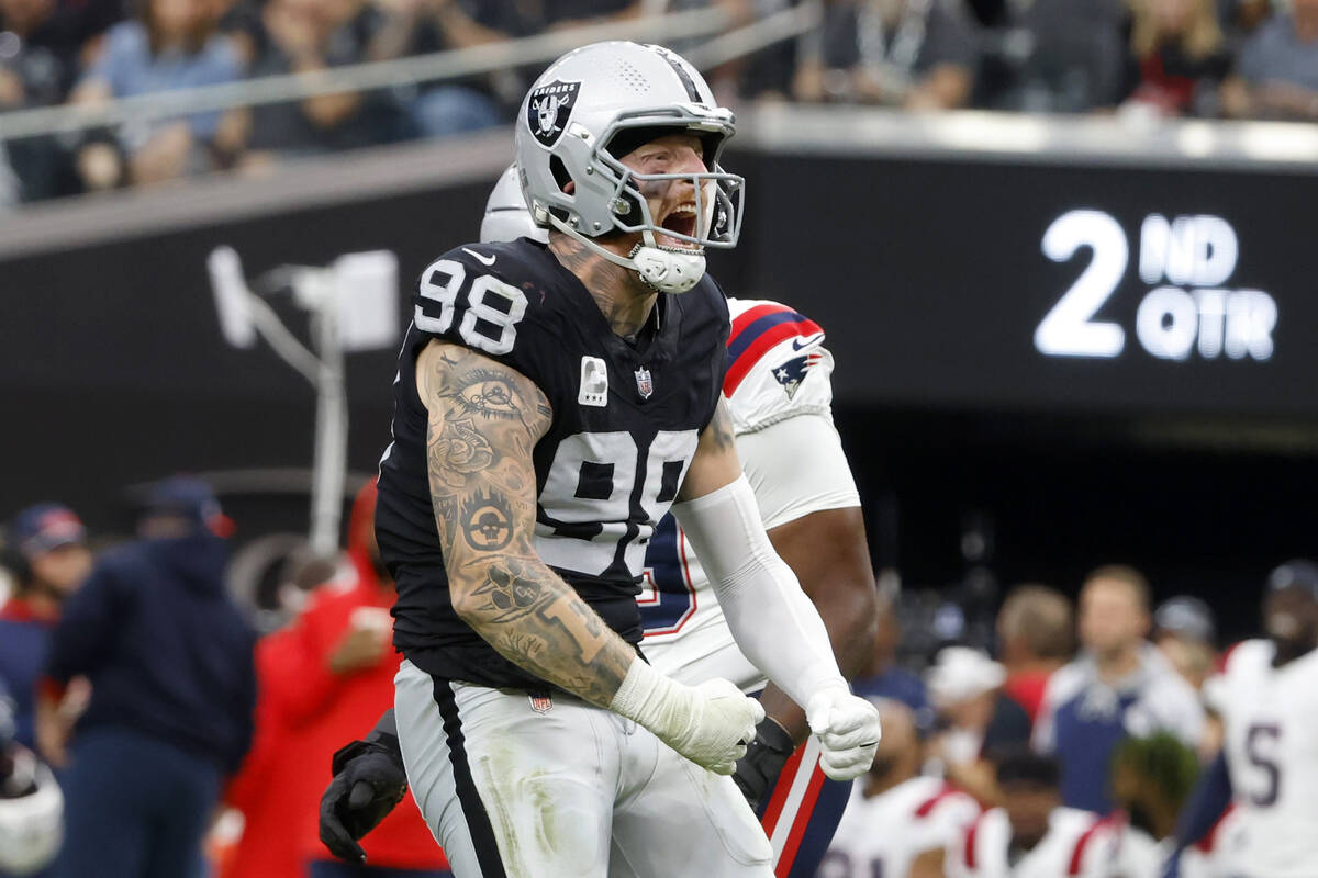 Raiders defensive end Maxx Crosby (98) reacts after sucking New England Patriots quarterback Ma ...