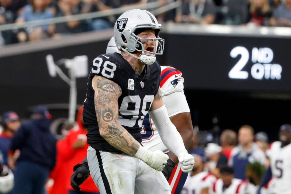 Raiders defensive end Maxx Crosby (98) reacts after sucking New England Patriots quarterback Ma ...