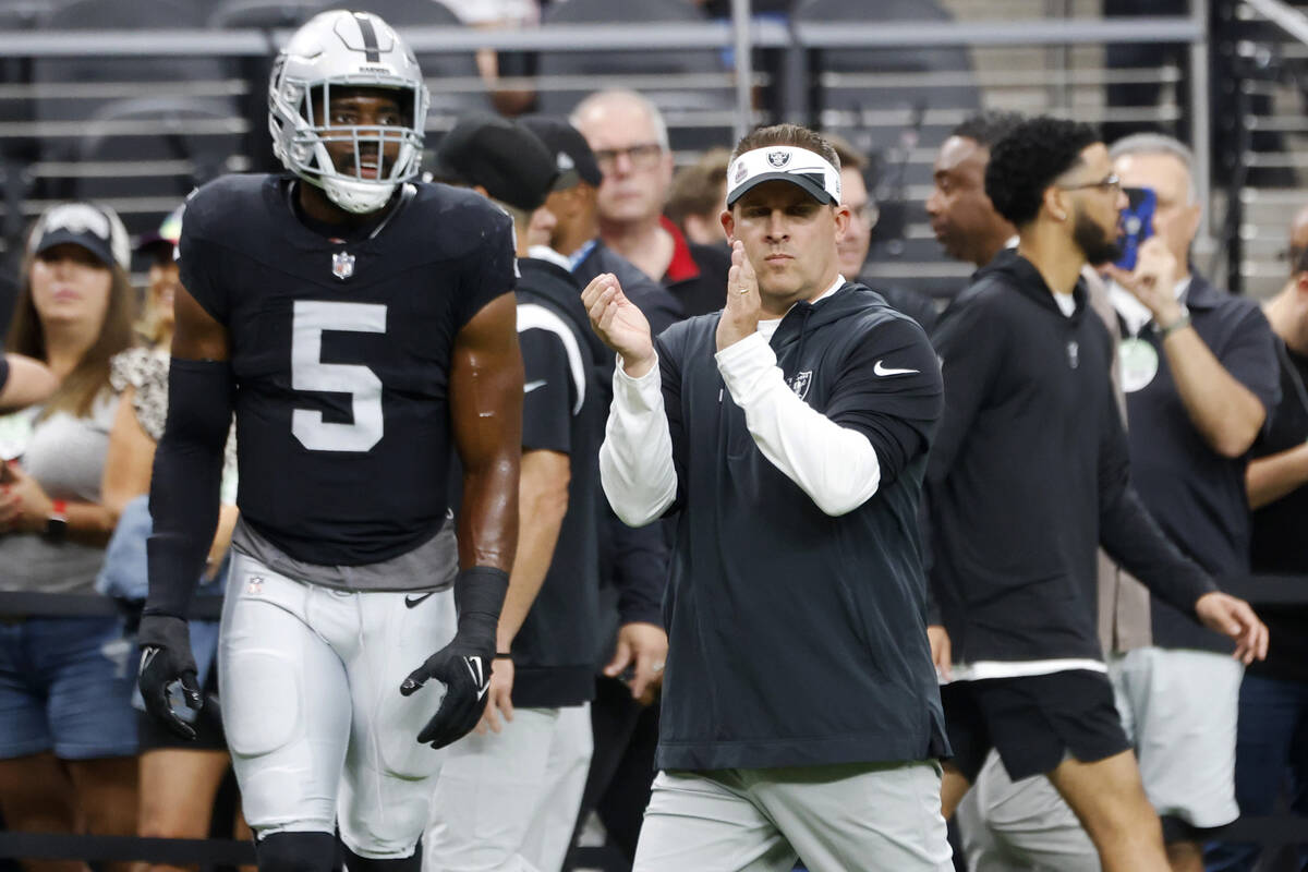 Raiders head coach Josh McDaniels reacts to a play during the first half of an NFL football gam ...