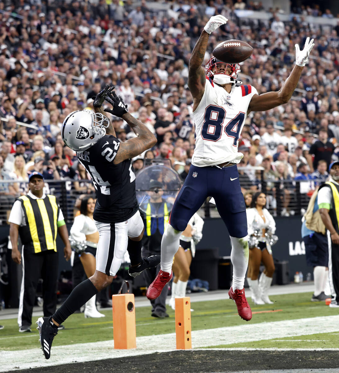 Raiders cornerback Marcus Peters (24) tries to catch the ball deflected by New England Patriots ...