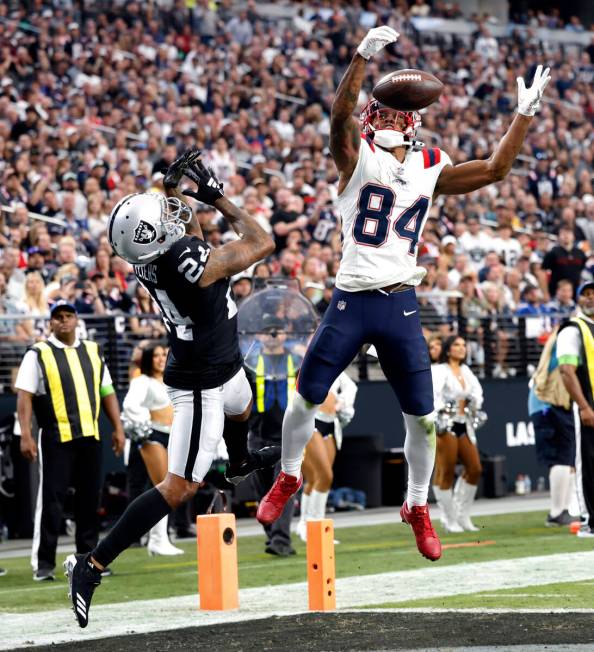 Raiders cornerback Marcus Peters (24) tries to catch the ball deflected by New England Patriots ...