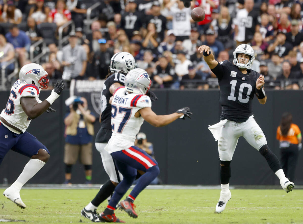 Raiders quarterback Jimmy Garoppolo (10) throws under pressure during an NFL football game agai ...