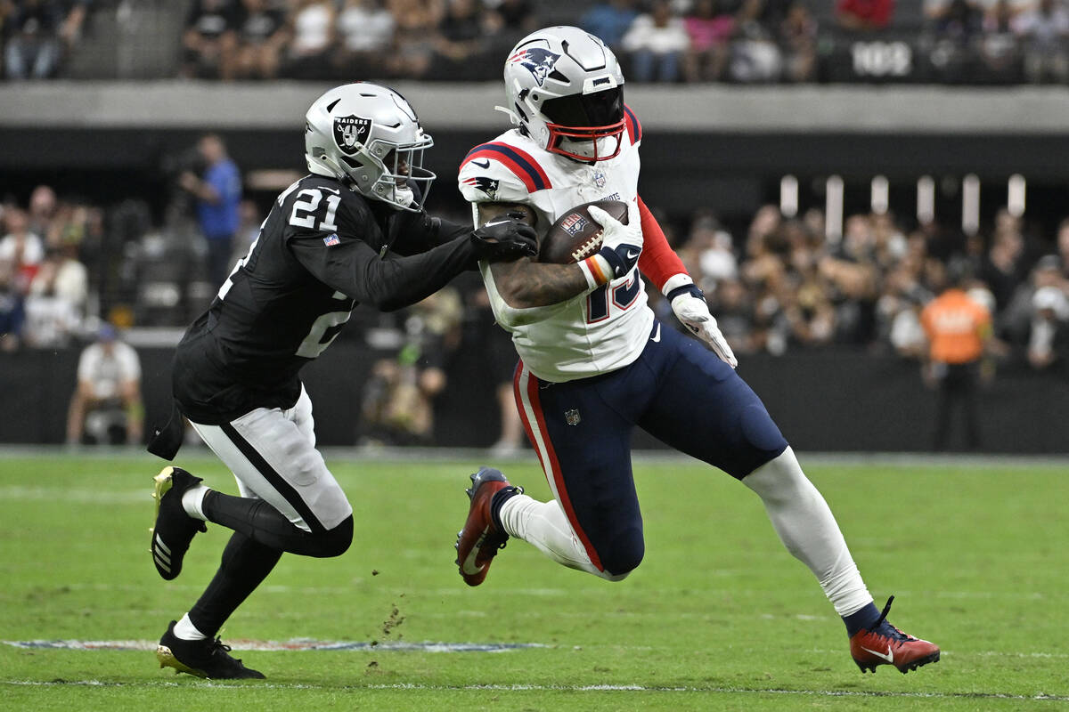 New England Patriots running back Ezekiel Elliott (15) runs with the ball as Las Vegas Raiders ...