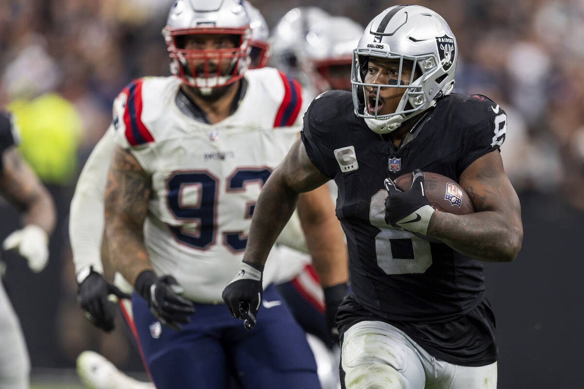 Las Vegas Raiders running back Josh Jacobs (8) runs the ball against the New England Patriots i ...