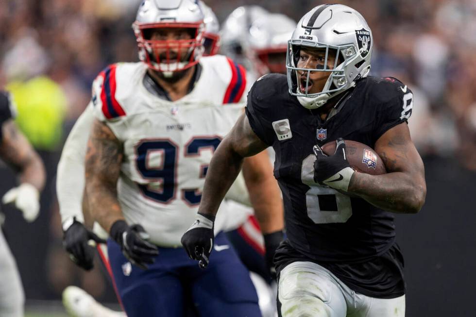 Las Vegas Raiders running back Josh Jacobs (8) runs the ball against the New England Patriots i ...