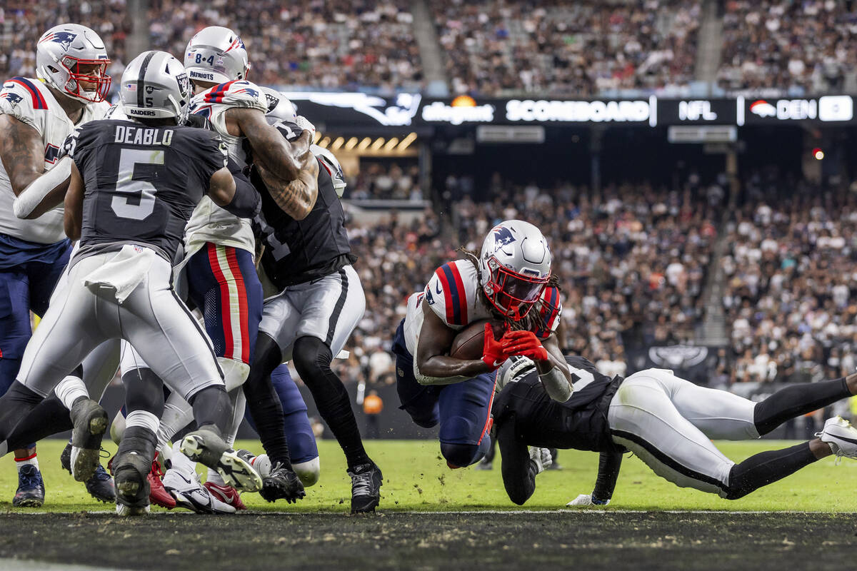 New England Patriots running back Rhamondre Stevenson (38) runs the ball and scores a touchdown ...