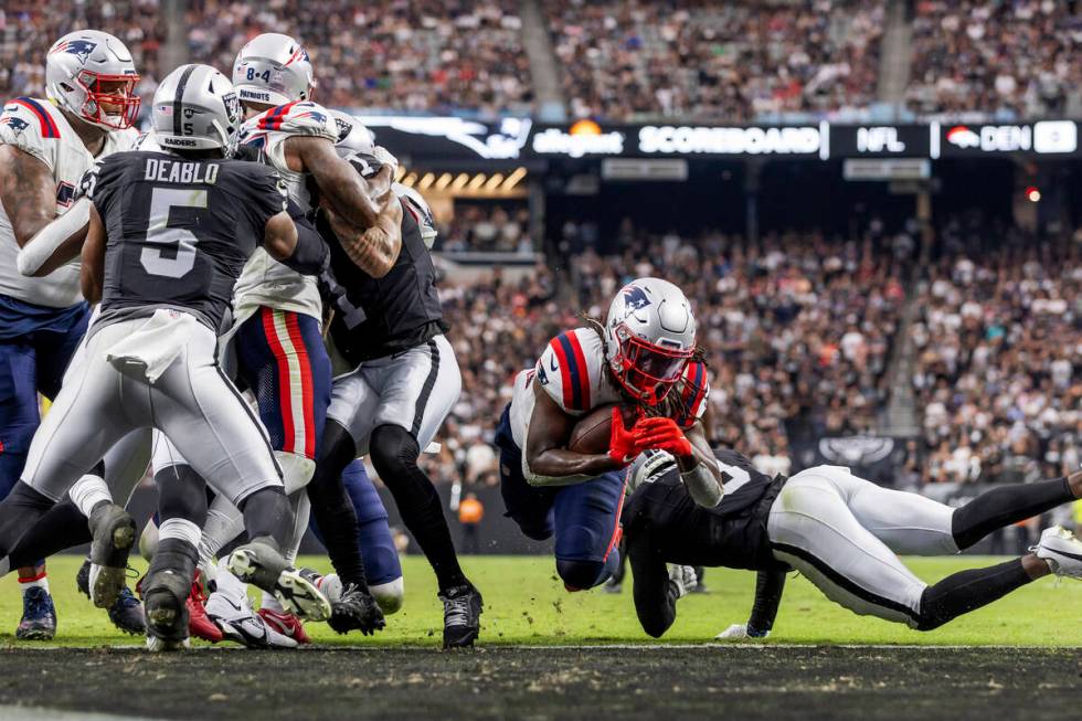 New England Patriots running back Rhamondre Stevenson (38) runs the ball and scores a touchdown ...