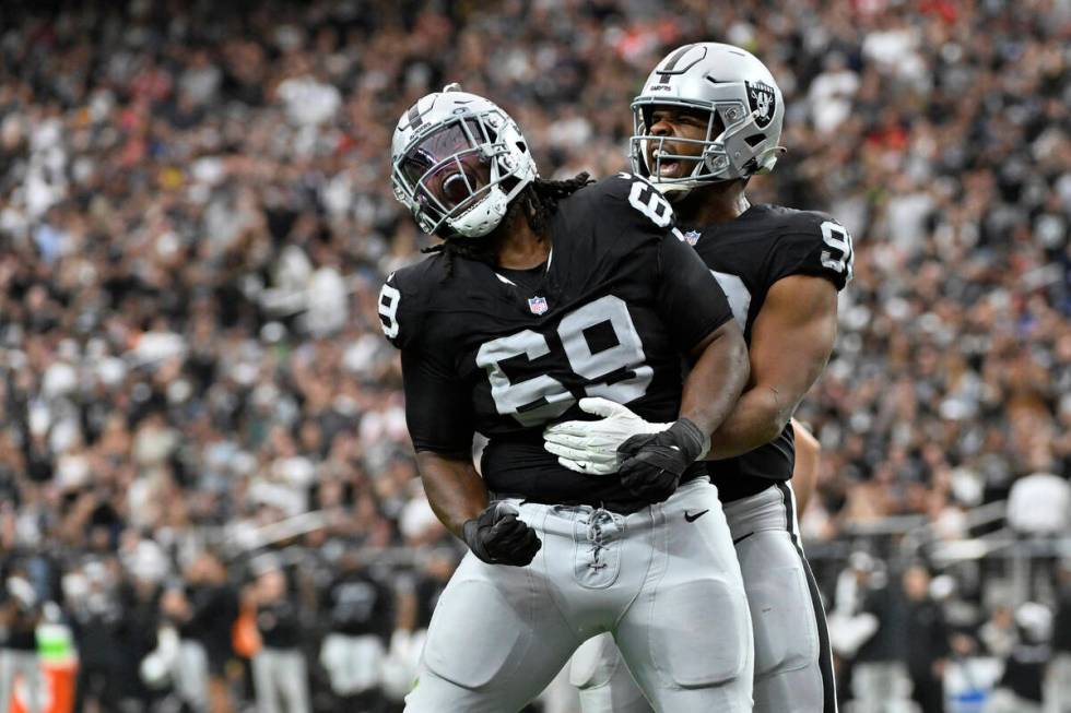 Las Vegas Raiders defensive tackle Adam Butler, left, and defensive tackle Jerry Tillery celebr ...