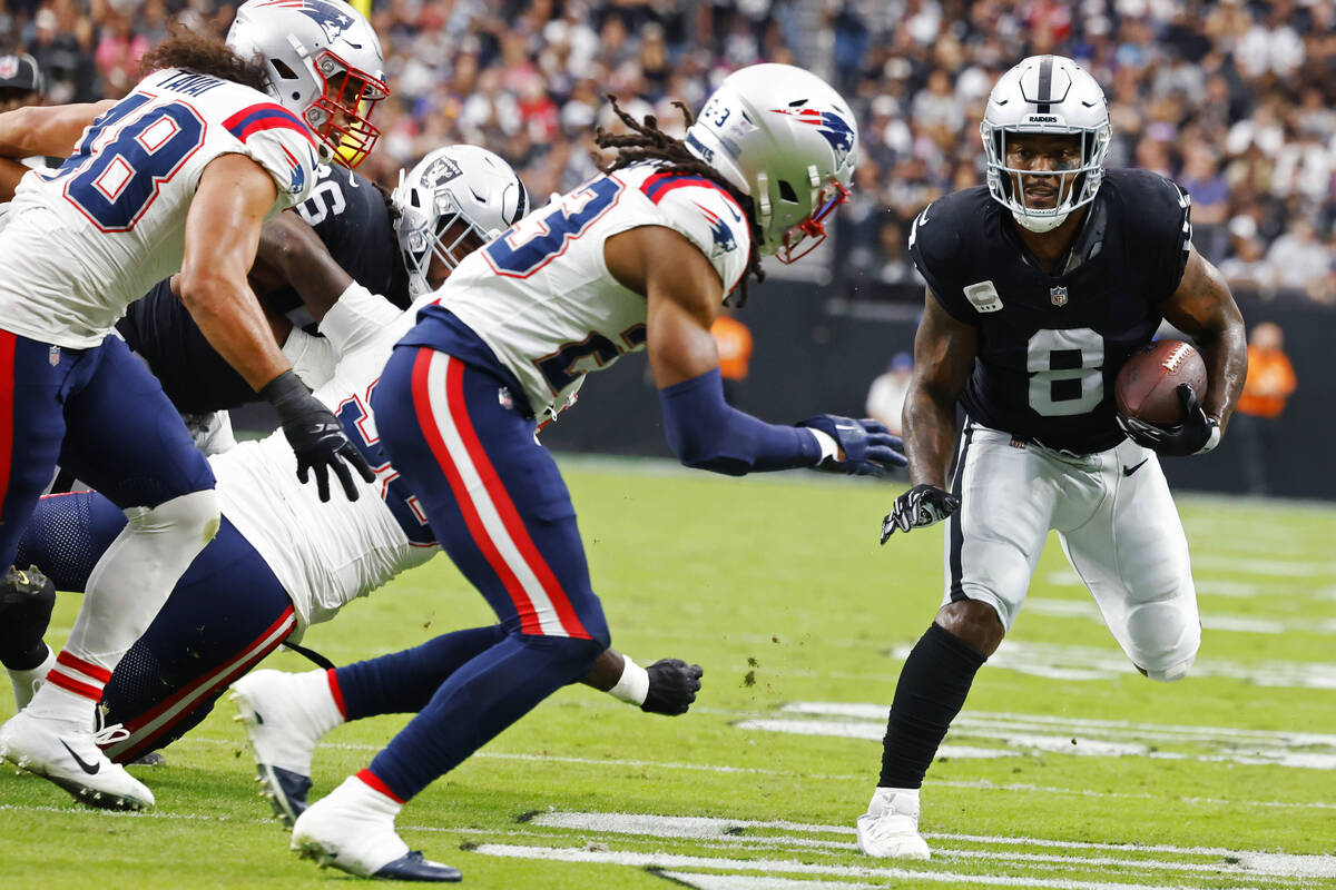 Raiders running back Josh Jacobs (8) runs with the ball during the first half of an NFL footbal ...