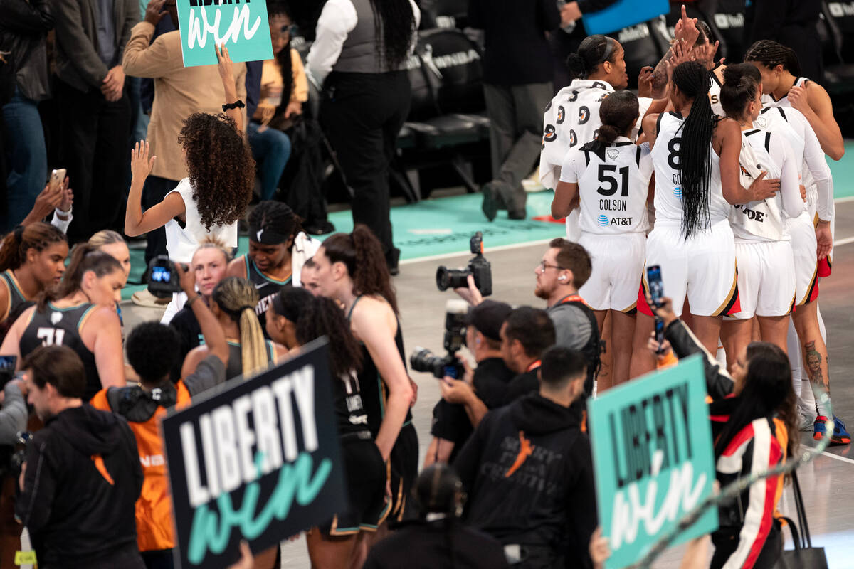 The Las Vegas Aces gather after losing Game 3 of a WNBA basketball final series against the New ...