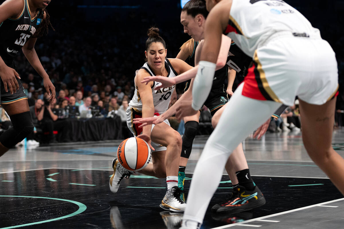 New York Liberty forward Breanna Stewart, center right, steals the ball from Las Vegas Aces gua ...