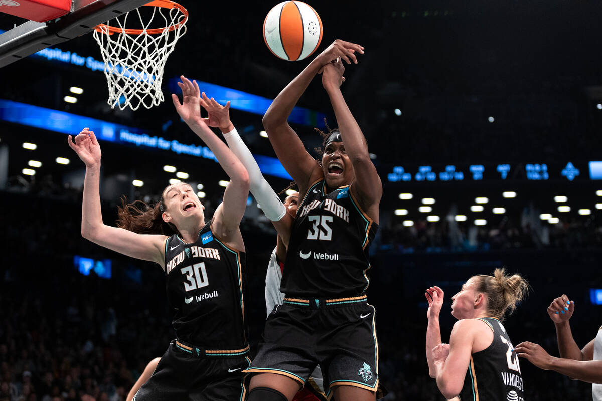 New York Liberty forwards Breanna Stewart (30) and Jonquel Jones (35) overpower a shot by Las V ...