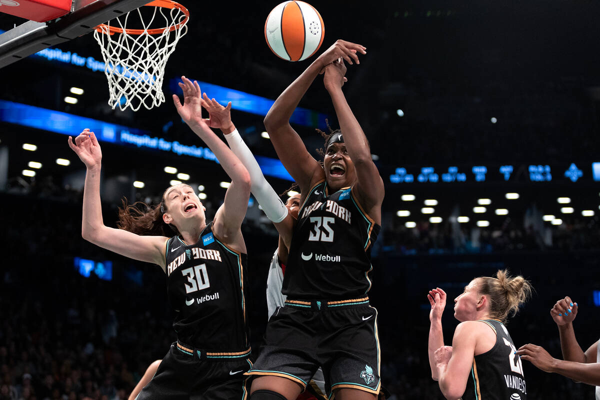New York Liberty forwards Breanna Stewart (30) and Jonquel Jones (35) overpower a shot by Las V ...