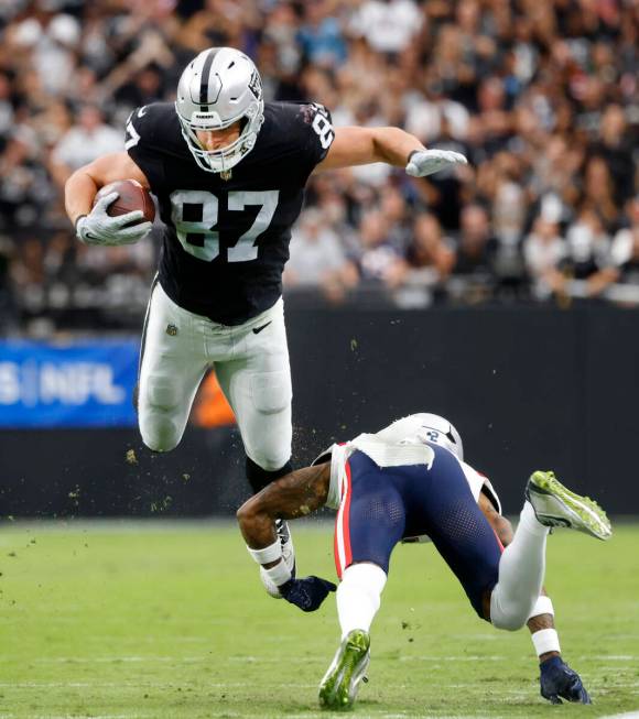 Raiders tight end Michael Mayer (87) leaps over New England Patriots cornerback Jalen Mills (2) ...