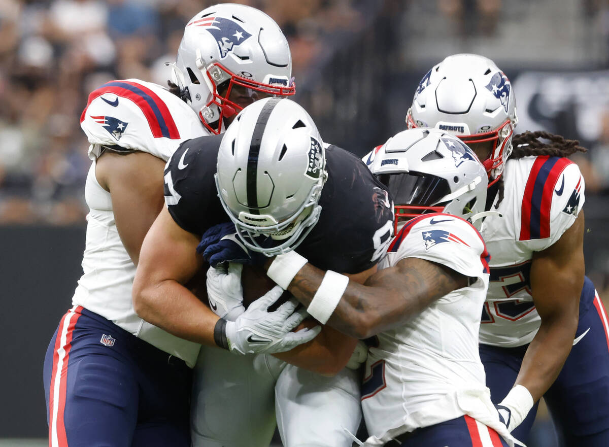 Raiders tight end Michael Mayer (87) breaks through tackles by New England Patriots defense dur ...