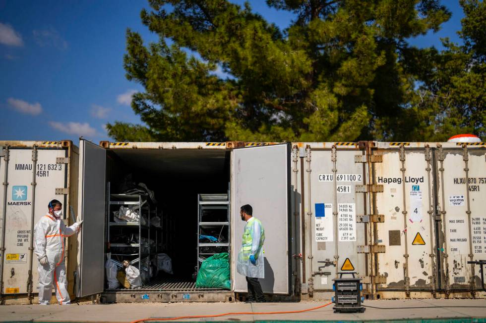 The bodies of Israelis killed in an unprecedented Hamas attack are gathered for identification ...