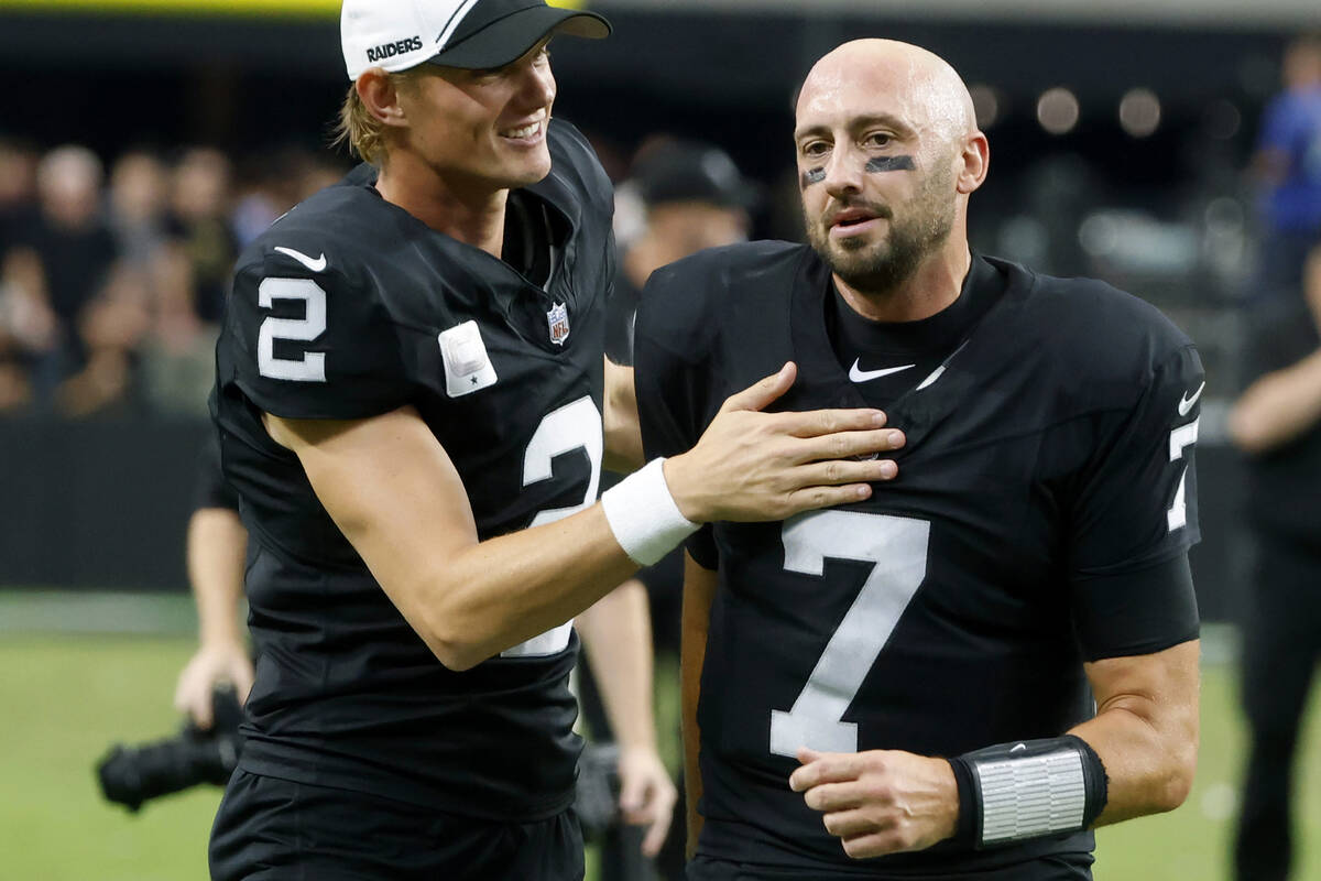 Raiders quarterback Brian Hoyer (7) and place kicker Daniel Carlson (2) leave the field after d ...