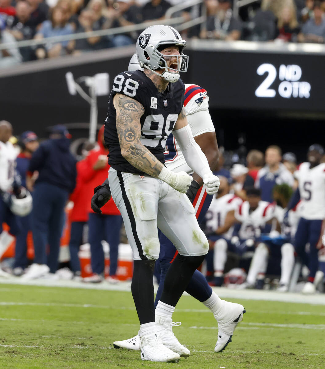 Raiders defensive end Maxx Crosby (98) reacts after sucking New England Patriots quarterback Ma ...