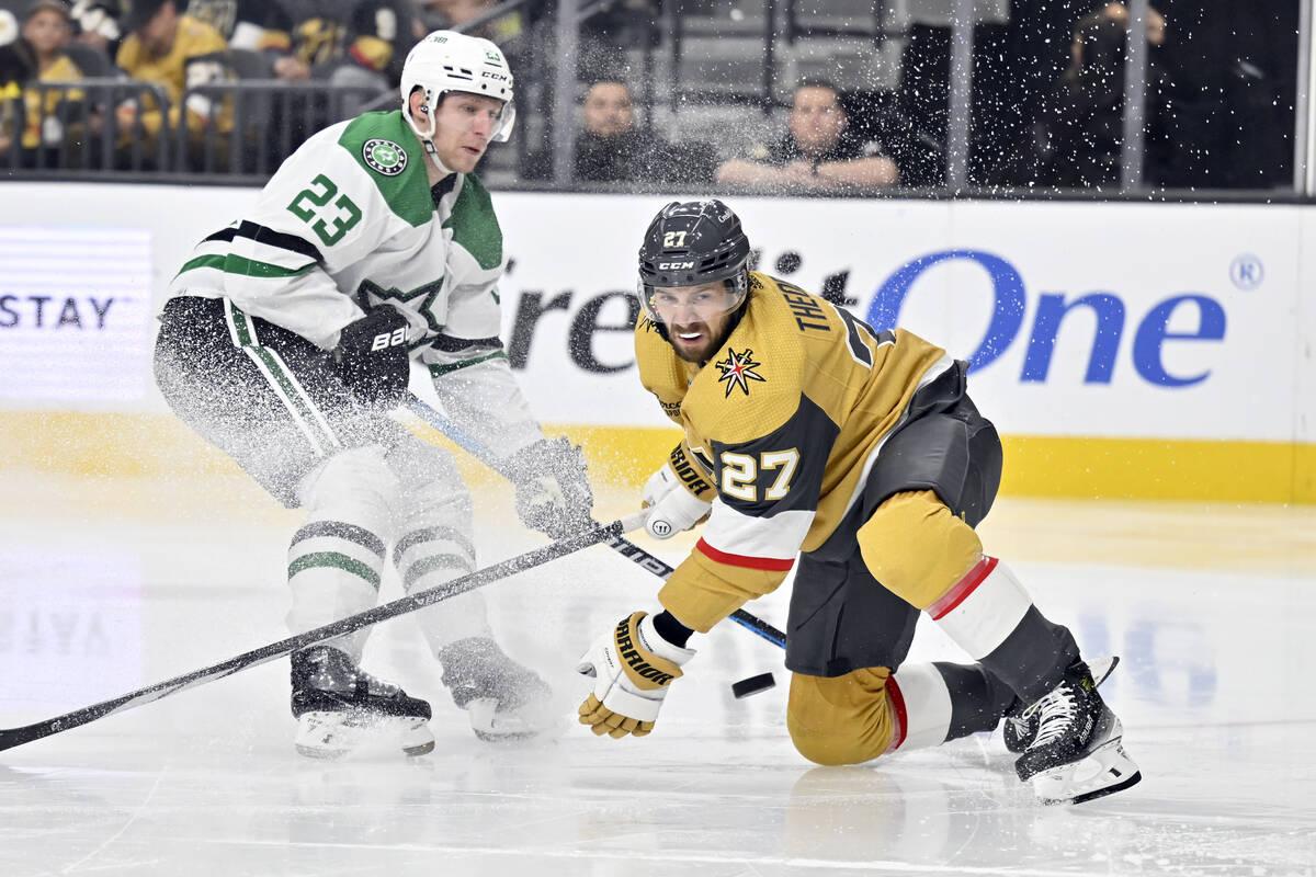 Vegas Golden Knights defenseman Shea Theodore (27) eyes the puck against Dallas Stars defensema ...