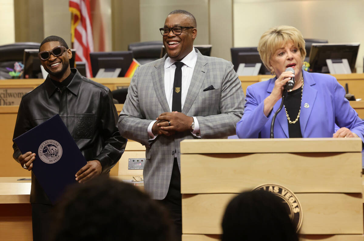 Usher, left, smiles after receiving a proclamation from Las Vegas City Councilman Cedric Crear ...