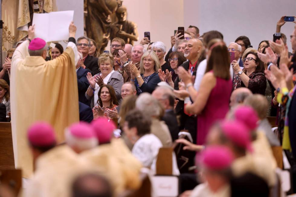 Archbishop George Leo Thomas holds the papal bull that had just been read by Apostolic Nuncio t ...